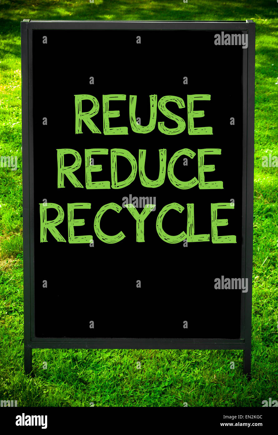 REUSE, REDUCE, RECYCLE message on sidewalk blackboard sign against ...
