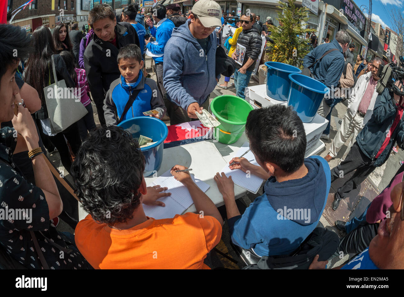 Jackson Heights, New York, USA. 26th Apr, 2015. Members of the Nepalese community in Jackson Heights in New York collect money for victims of the Nepalese earthquake, on Sunday, April 26, 2015. Jackson Heights has a sizable Nepalese community with many members worried about the whereabouts and safety of family and friends. Over 2500 people have died in the massive earthquake. Credit:  Richard Levine/Alamy Live News Stock Photo