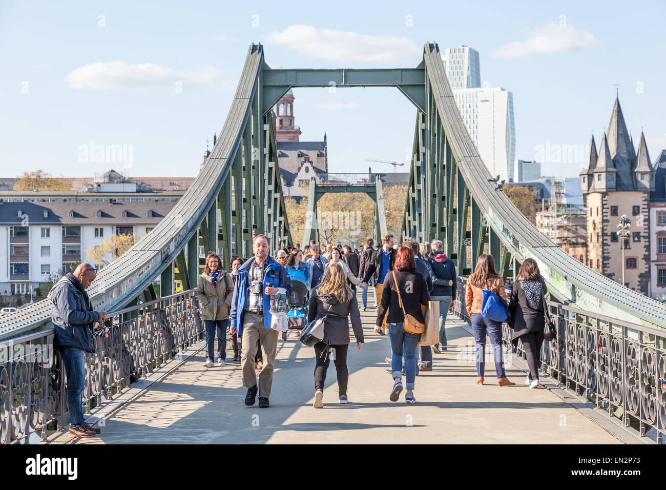 People on the old iron bridge (Eiserner Steg) over the river Main in Frankfurt Main, Germany Stock Photo