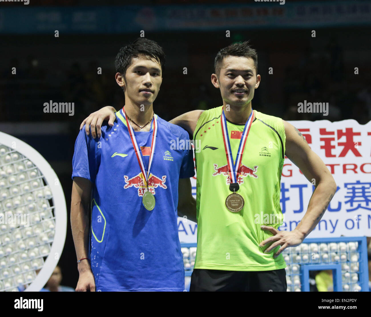 Dong Feng Citroen Badminton Asia Championships 2015 in Wuhan, China on April 26, 2015.Men's singles winner Lin Dan of China (R) poses with compatriot Tian Houwei following finals match. Stock Photo