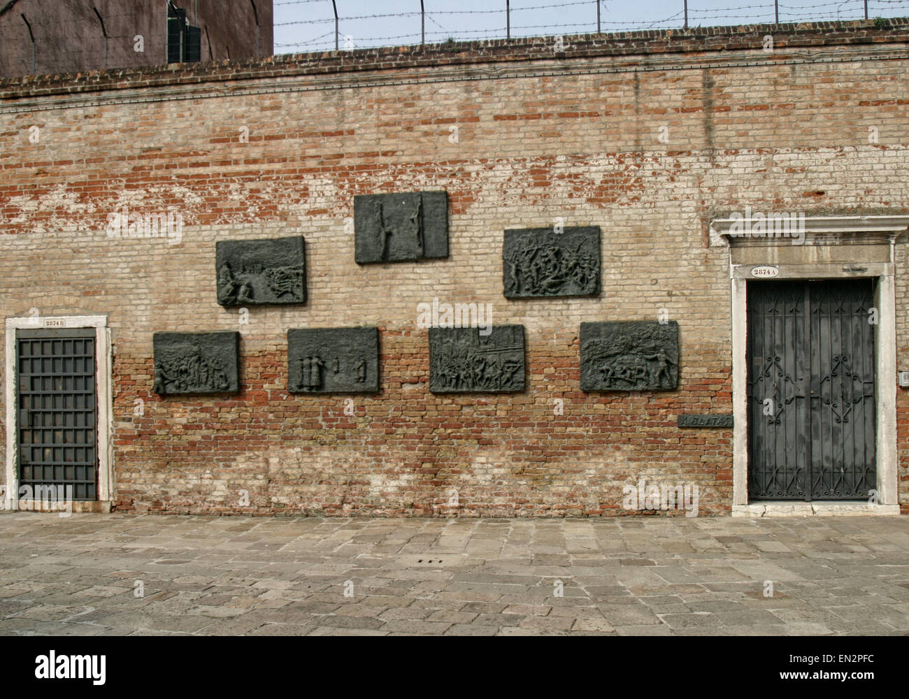 Venice, Province of Venice, ITALY. 7th Oct, 2004. In 1979 Arbit Blatas, a Lithuanian-born artist who lost his mother in the Holocaust, created this seven-panel bronze bas-relief Holocaust memorial, by the request of the Jewish Community of Venice. On a wall of the Campo del Nuovo Ghetto, it commemorates the night of Dec. 5, 1943, when the first 200 of the city's Jews were rounded up and marched out for deportation and death. Venice, a UNESCO World Heritage Site, is one of the most popular international tourist destinations. © Arnold Drapkin/ZUMA Wire/Alamy Live News Stock Photo