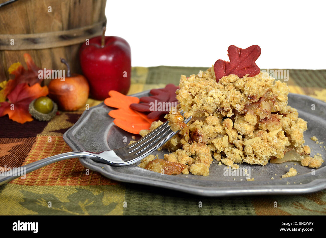 Apple crisp dessert with apples, acorn and fall leaves. Stock Photo