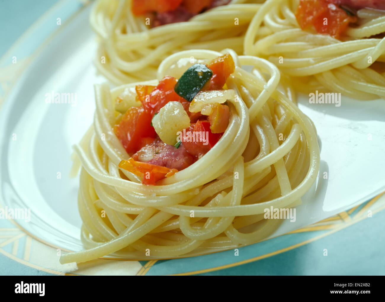 spiral squash spaghetti noodles with sausage and vegetable sauce . Stock Photo