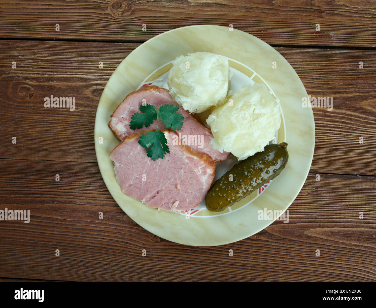 Traditional German Senfbraten with potatoes and pickles Stock Photo - Alamy