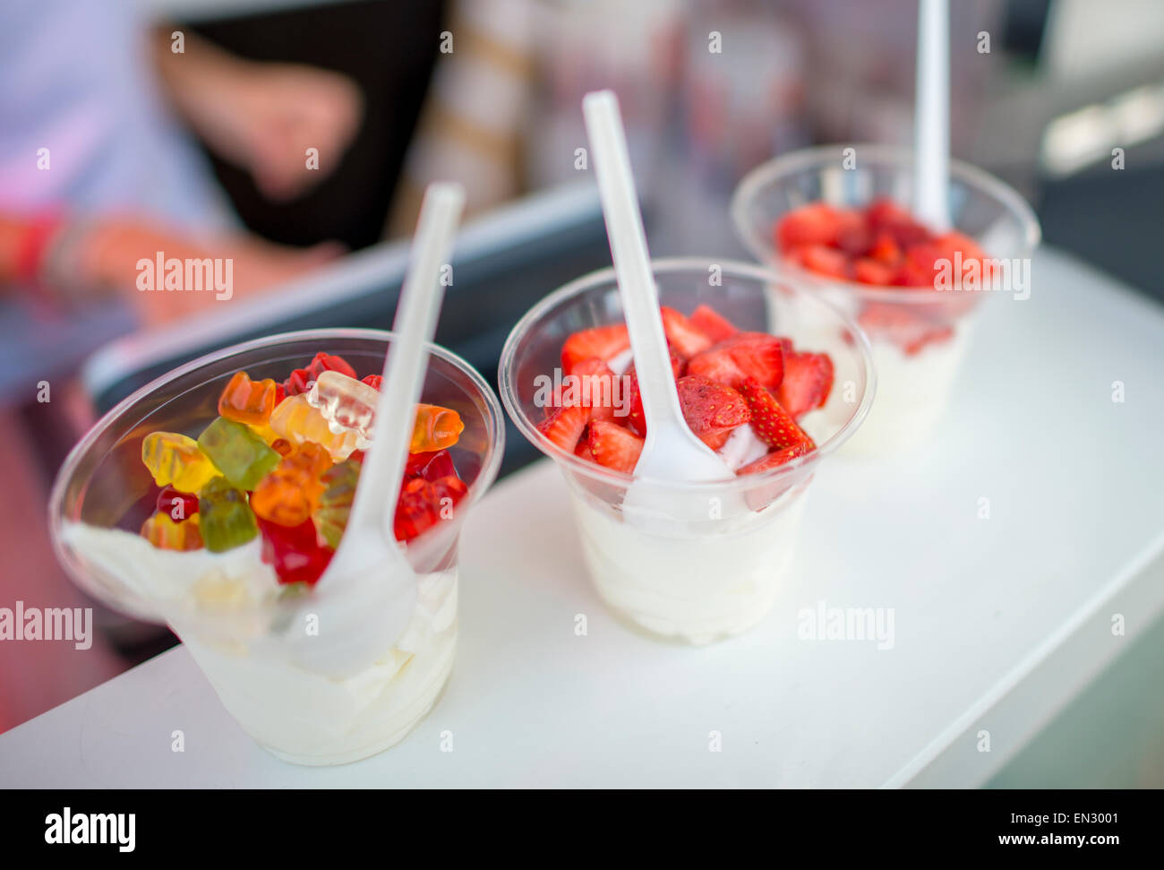 Soft ice cream topping with strawberries and gummy bears Stock Photo