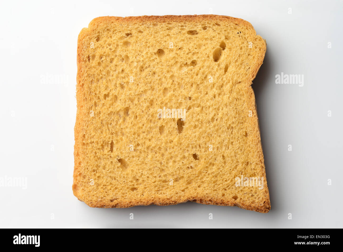 Whole wheat brown bread slice on white background Stock Photo - Alamy