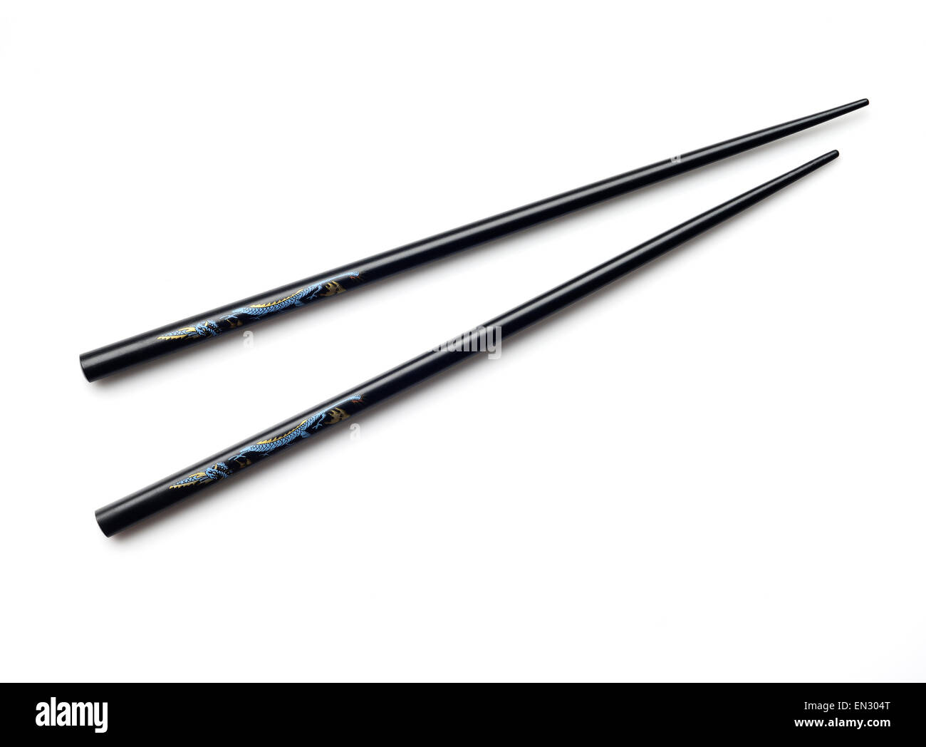 High resolution image of black wooden chopsticks with blue and yellow dragon. Stock Photo