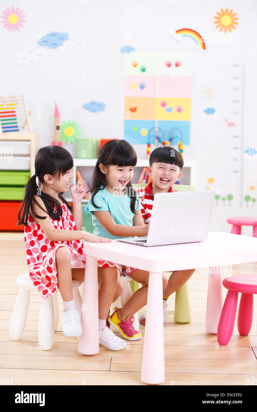In the kindergarten children to use the computer Stock Photo Alamy