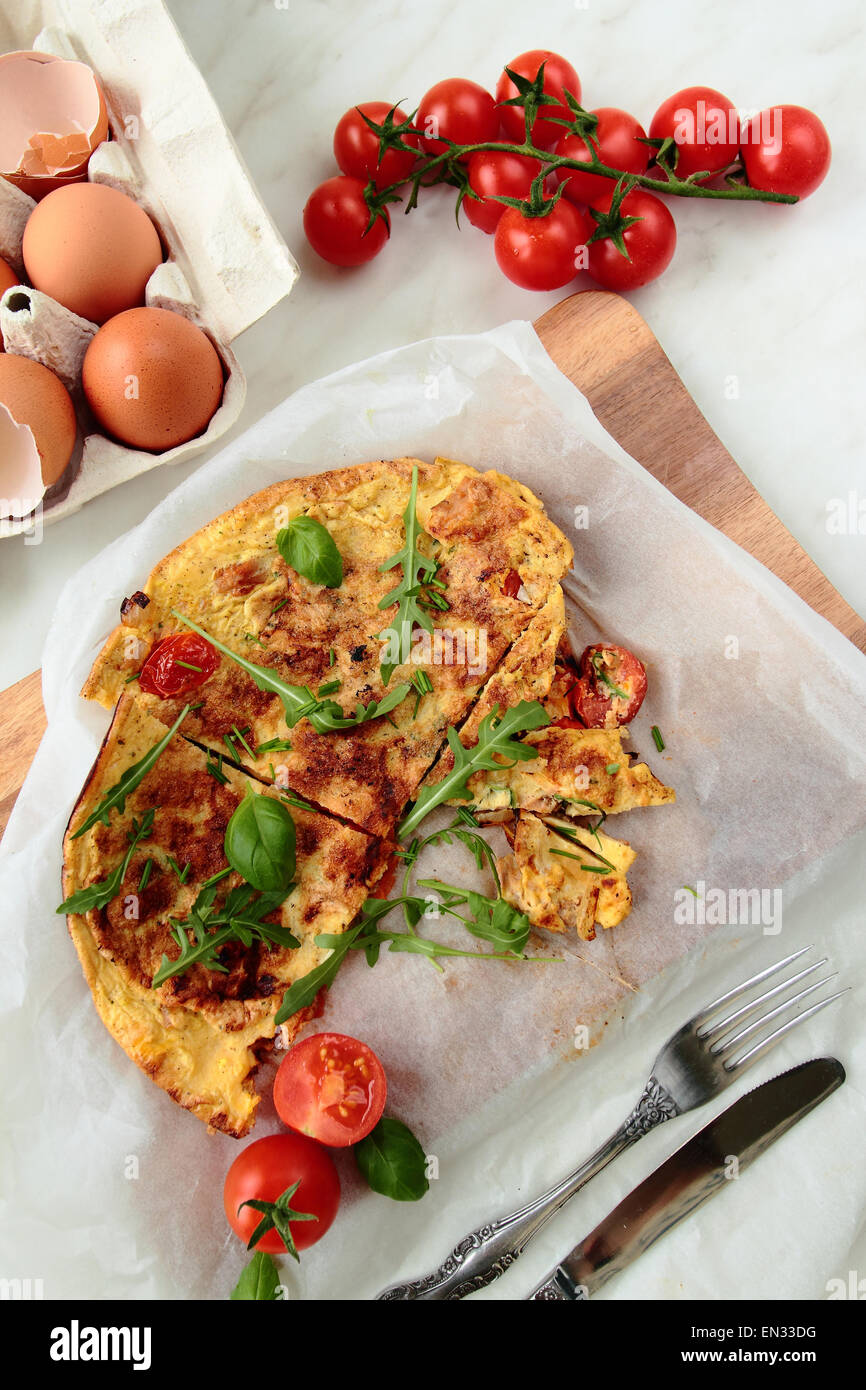 Omelet with fresh rucola and tomatoes for breakfast Stock Photo