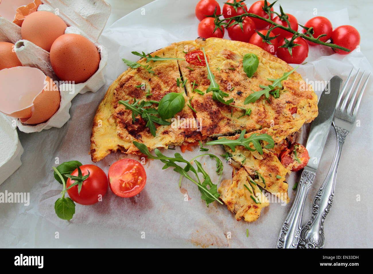 Delicious omelet with rucola and tomatoes for breakfast Stock Photo