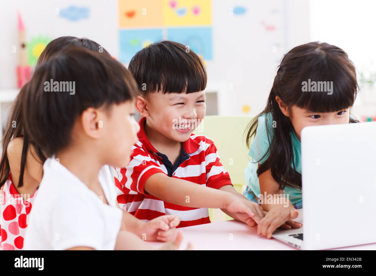 In the kindergarten children are using the computer Stock Photo Alamy