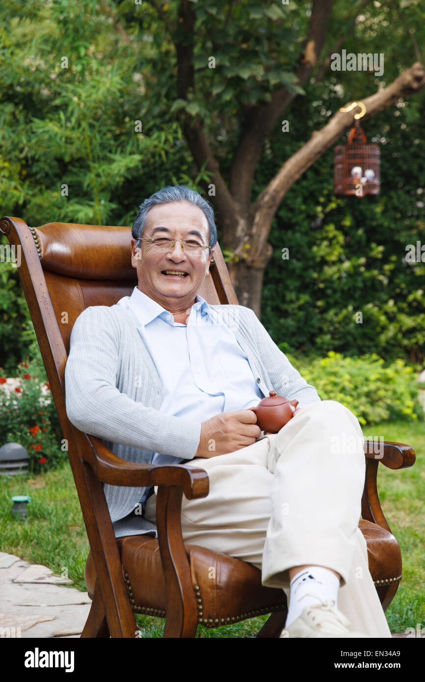 An old man was sitting in the garden Stock Photo - Alamy