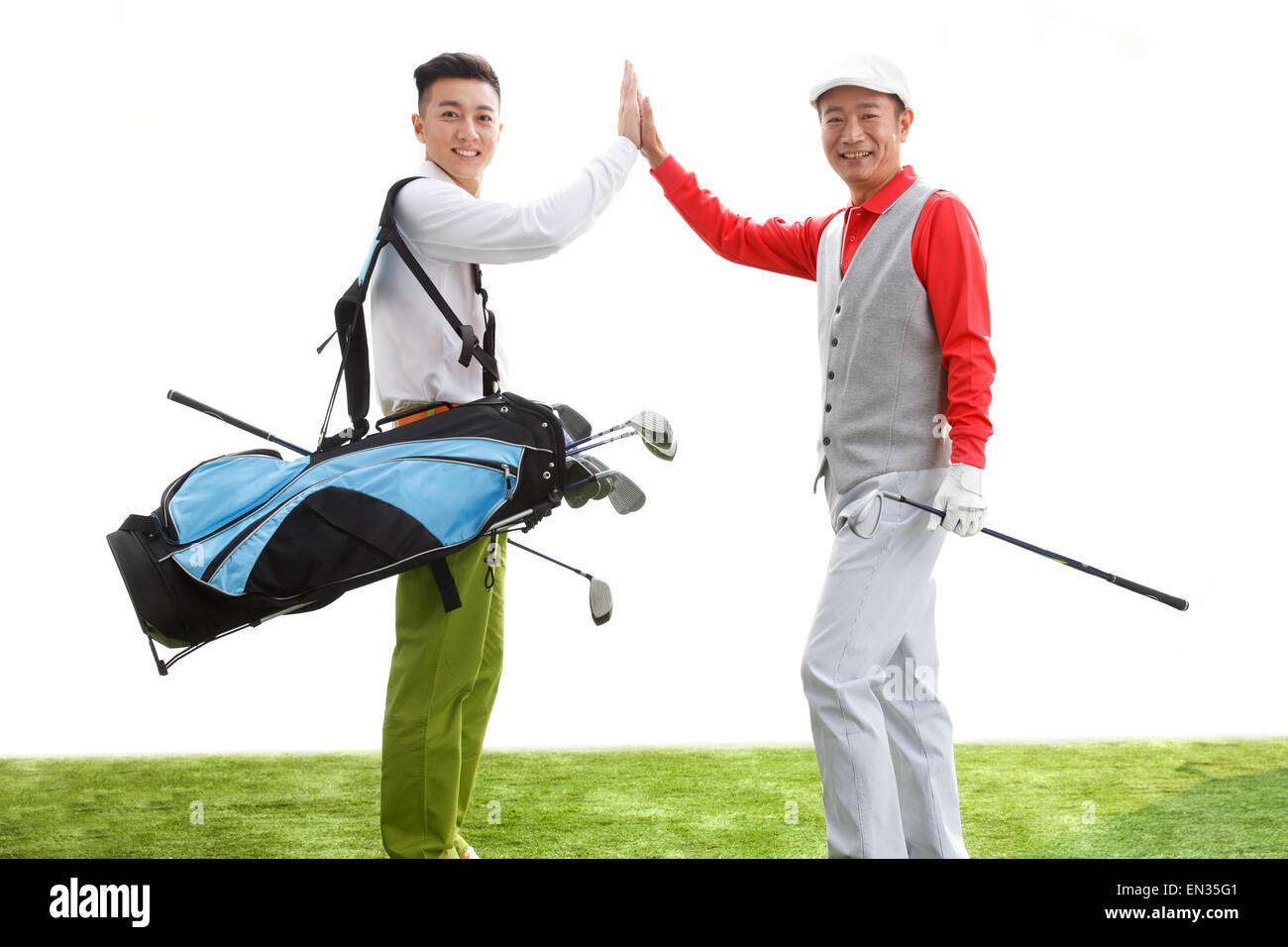 Two golfers in high fives Stock Photo