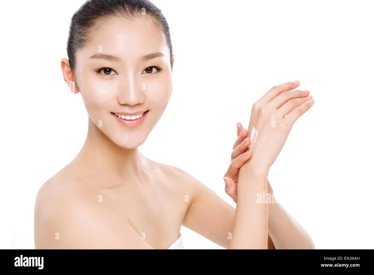 Beautiful oriental woman in painted skin care products Stock Photo
