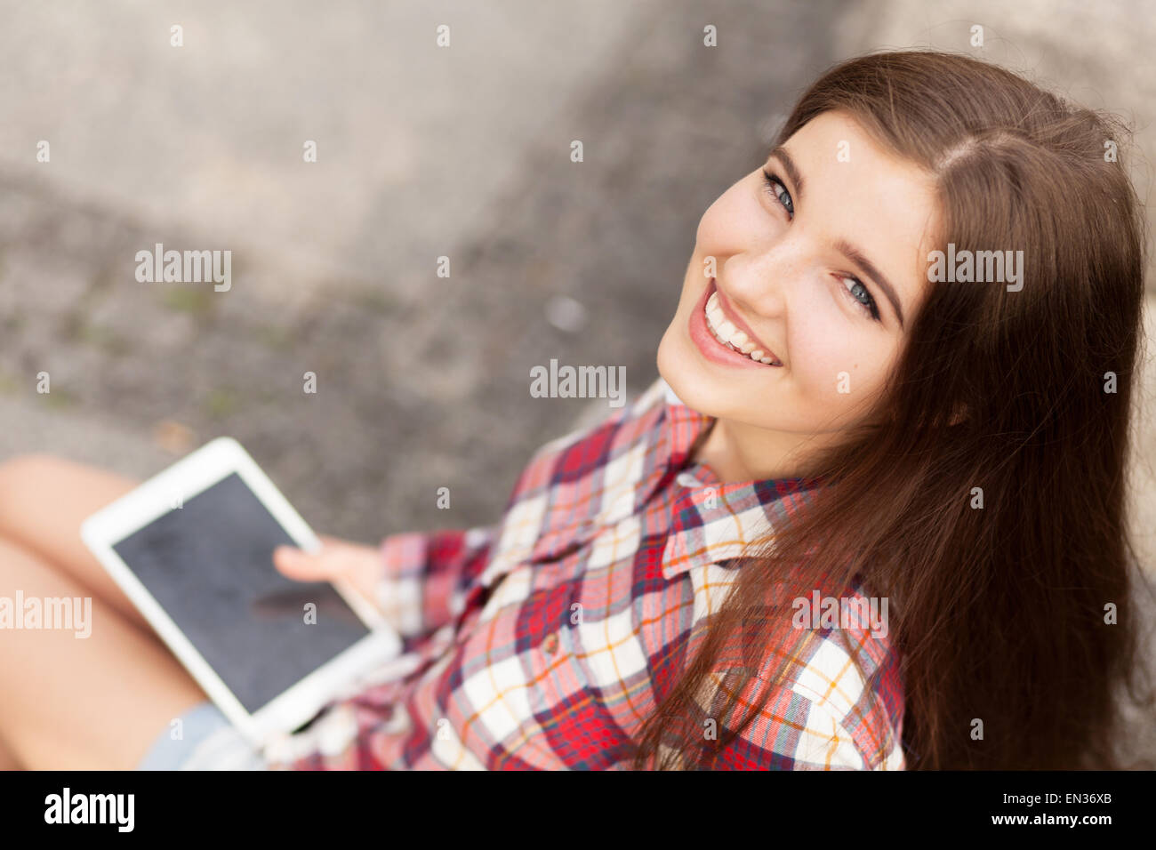 Face portrait of young woman using a tablet pc Stock Photo