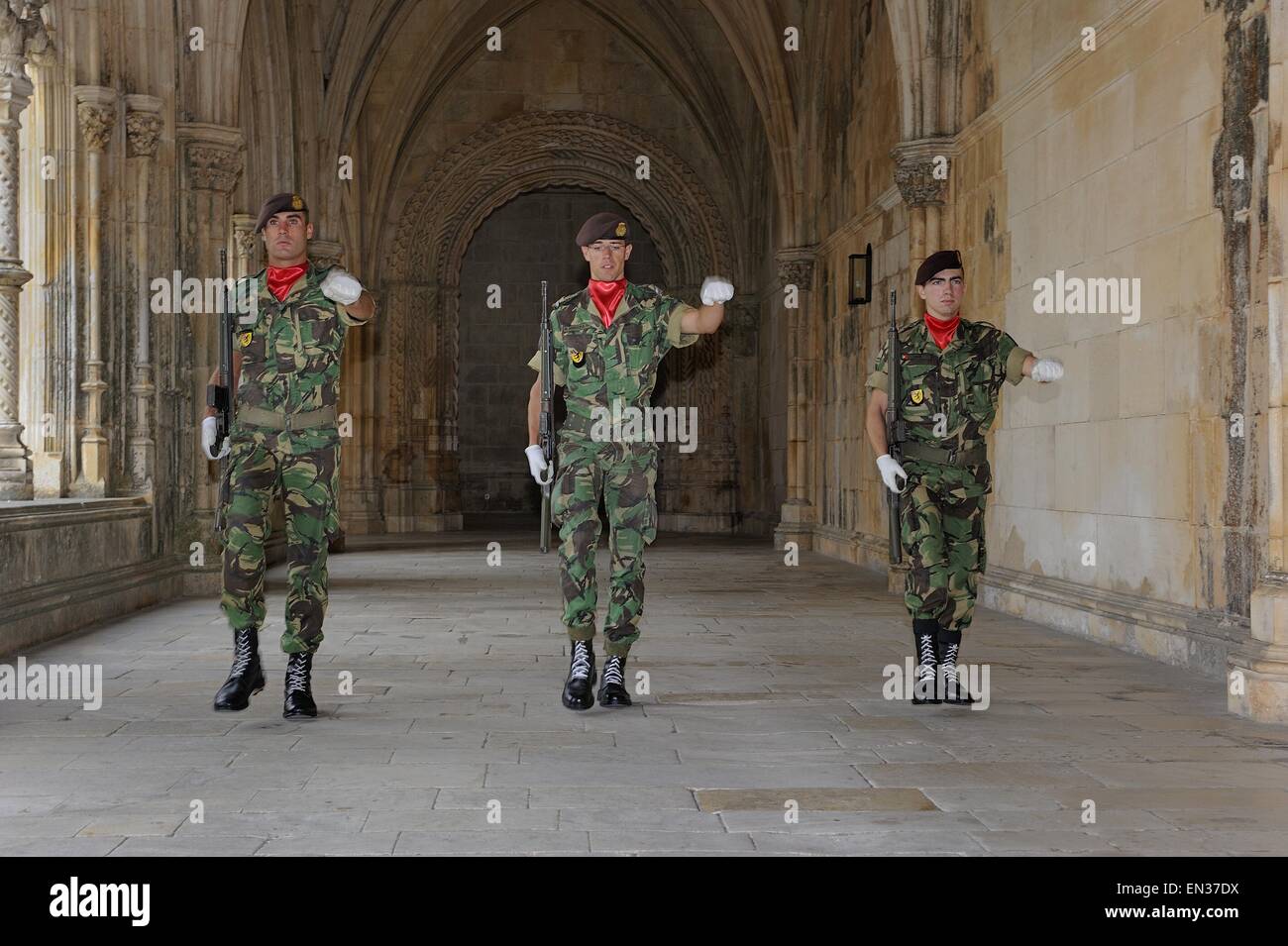 Three Portuguese soldiers with guns in the cloister at the changing of the guard for the grave of an unknown soldier, Batalha Stock Photo