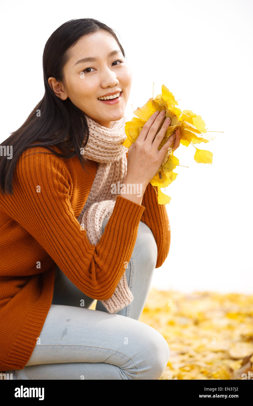 Happy young woman with leaves Stock Photo - Alamy