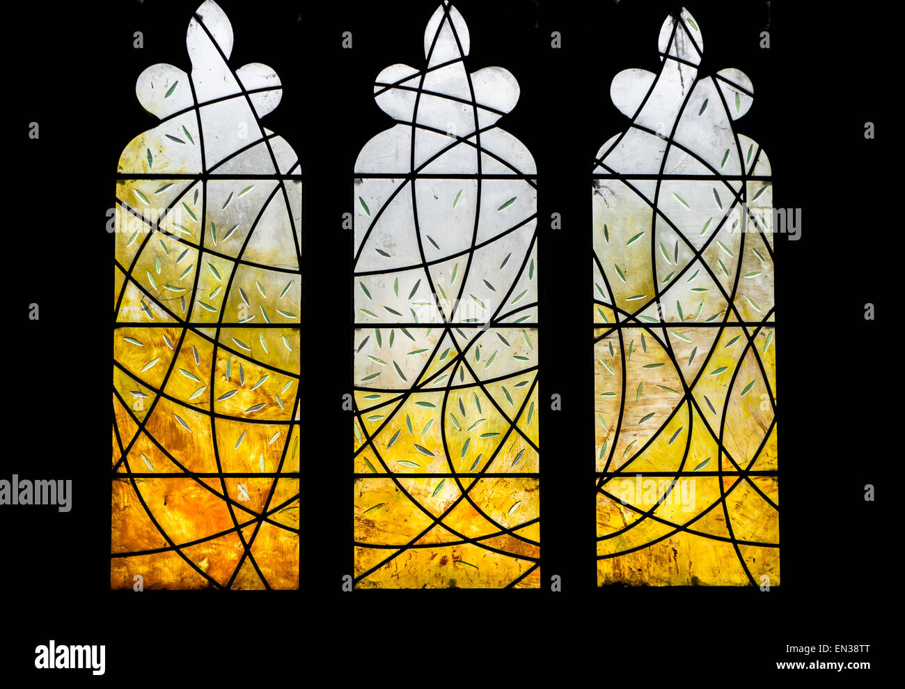 A modern stained glass design n a traditional church window. Stock Photo