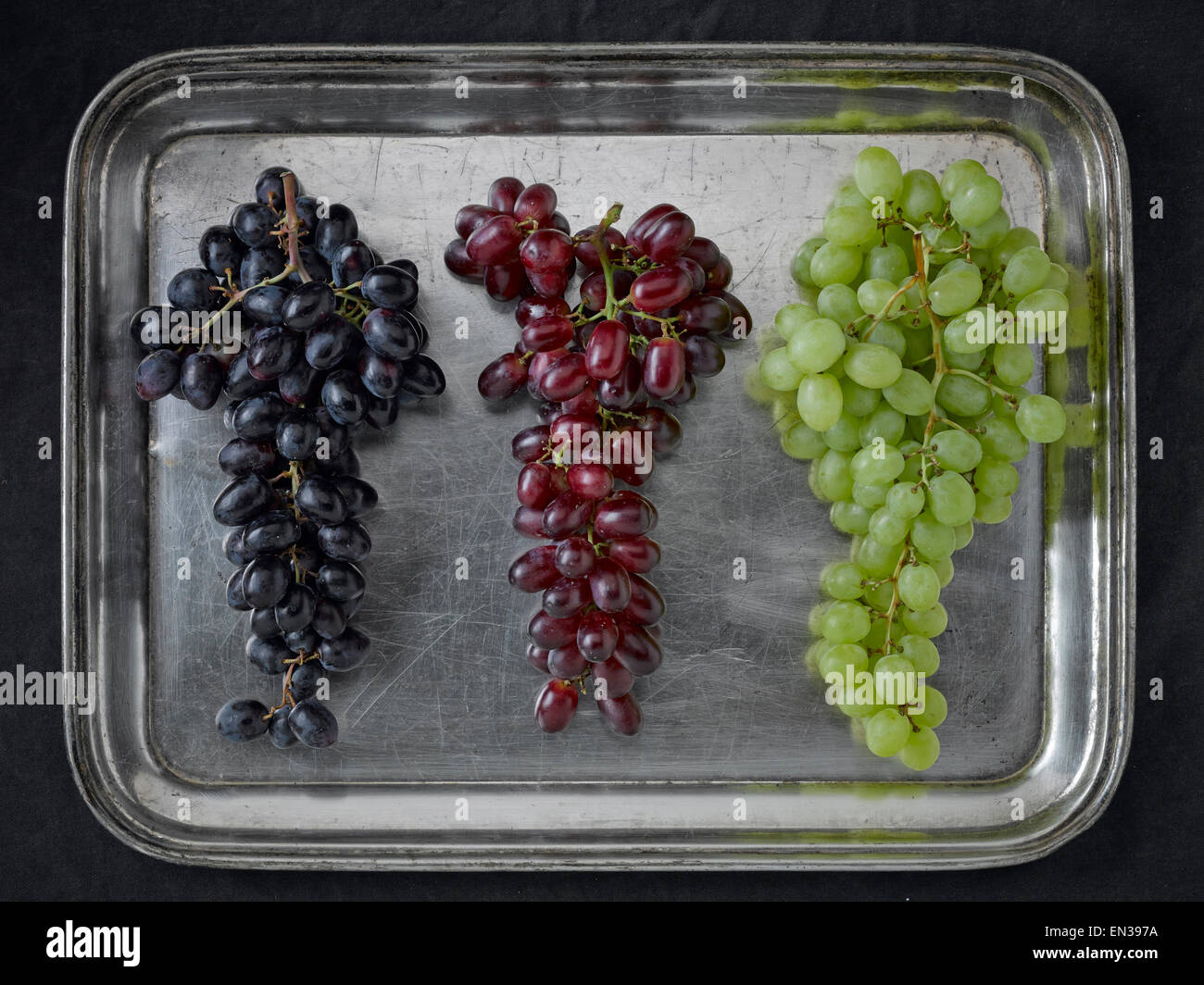 Three varieties of grapes on a silver platter Stock Photo Alamy