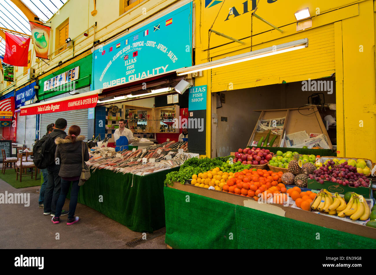 The gentrification of Brixton in the Brixton Village Granville arcade  indoor market Stock Photo