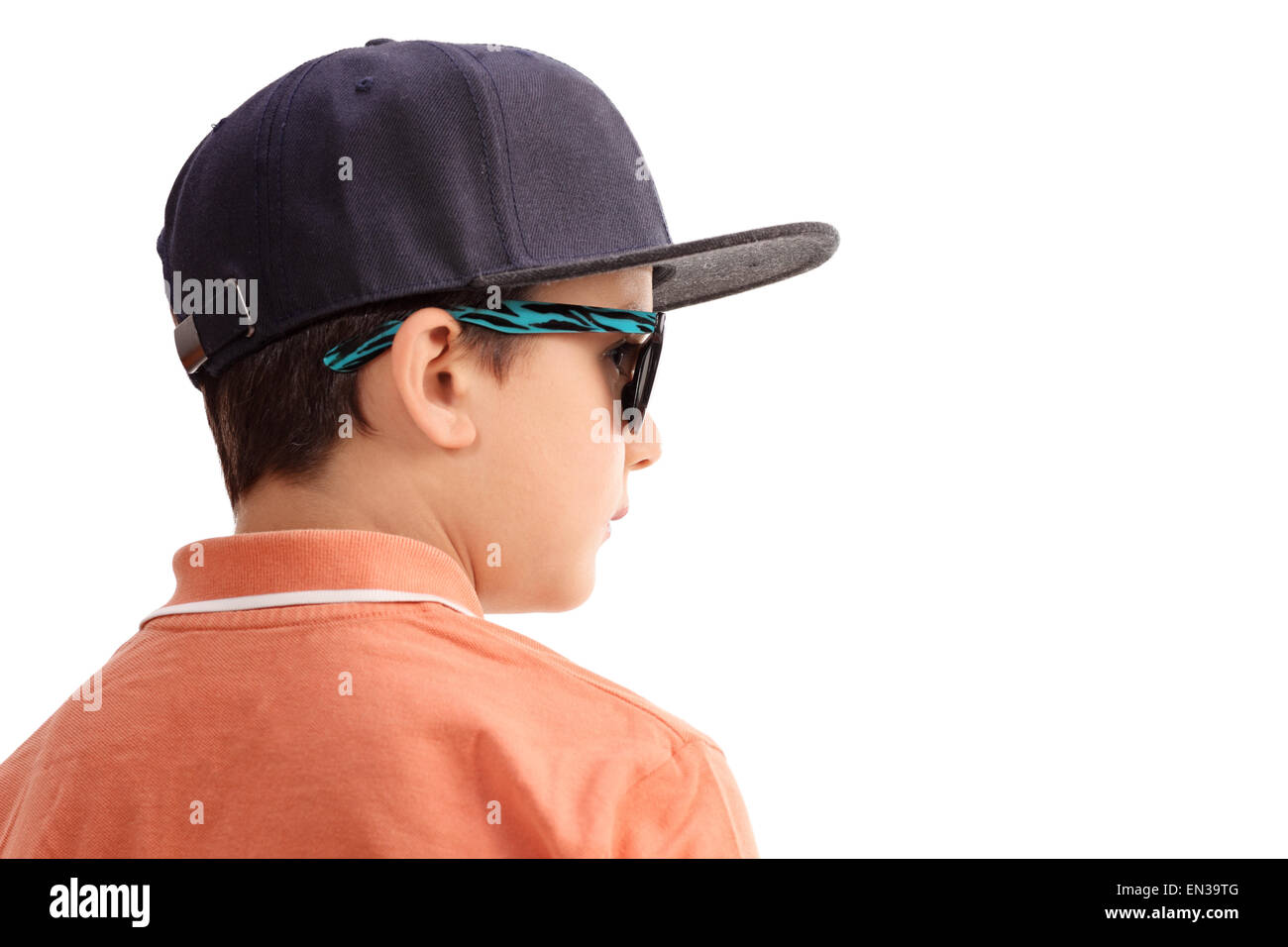 Cool little boy with a cap and sunglasses looking in the distance isolated on white background Stock Photo