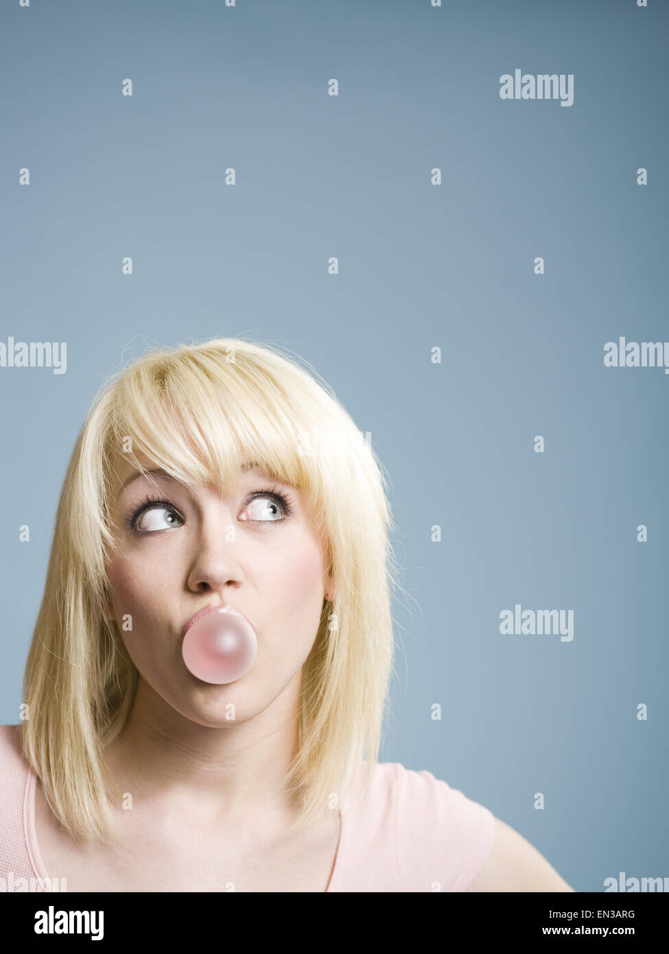 Woman blowing bubbles with chewing gum Stock Photo Alamy