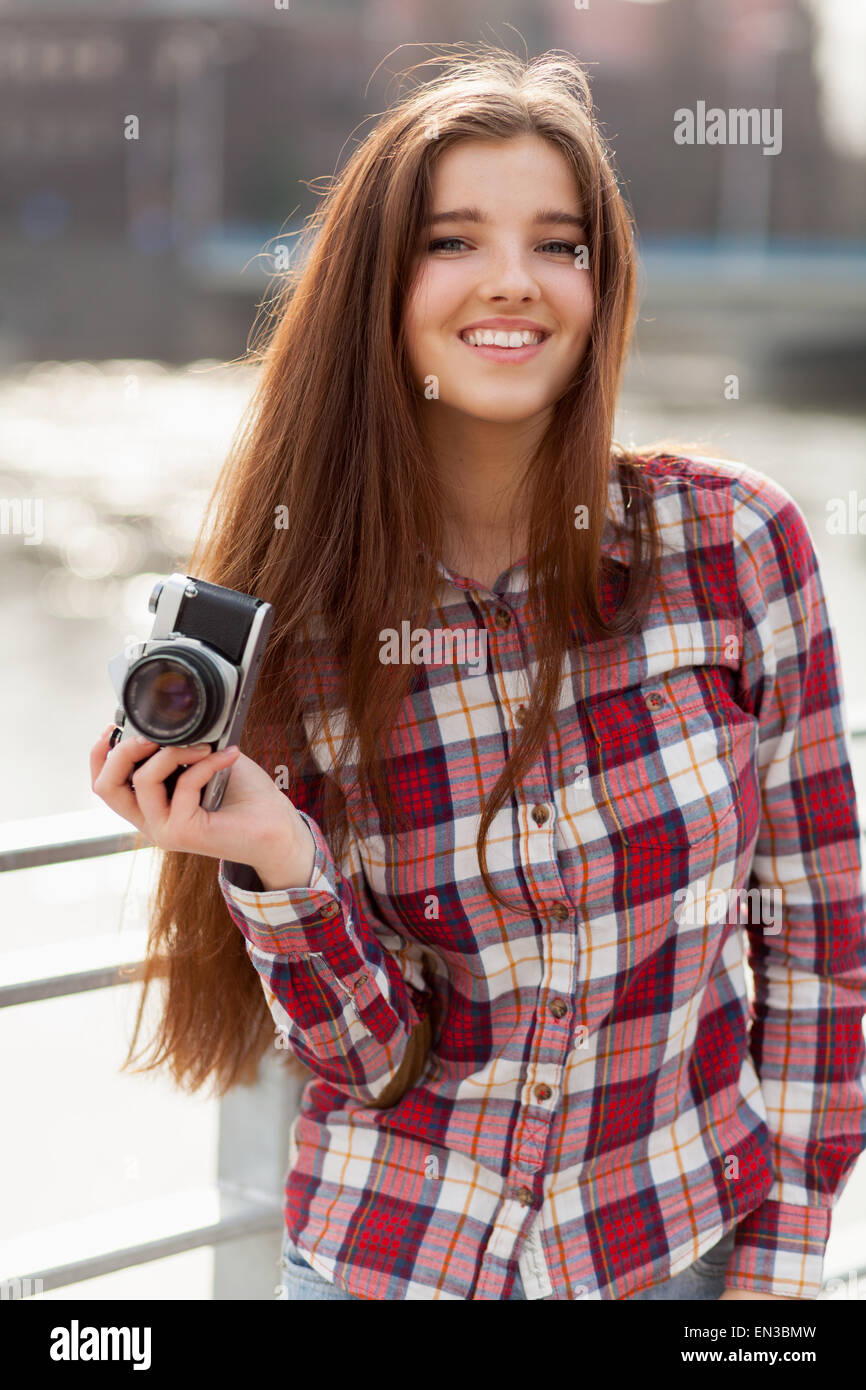 Portrait of a young woman with photo camera Stock Photo