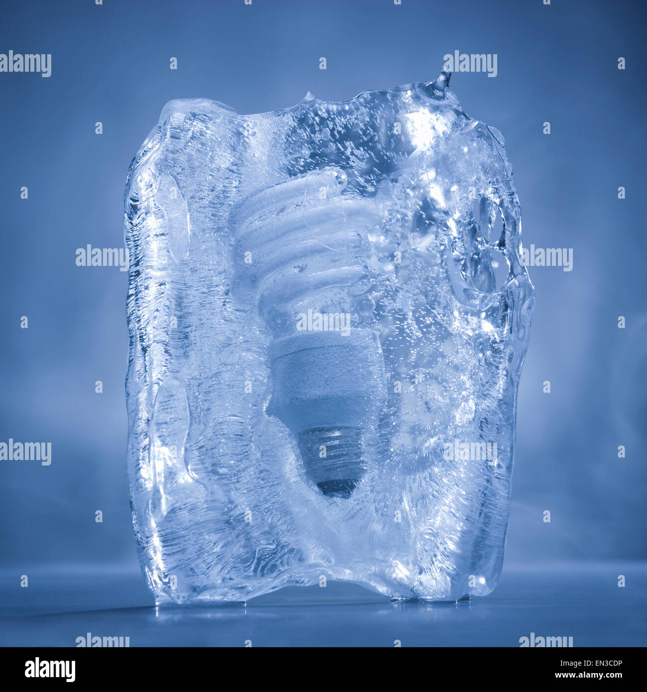 light bulb frozen in a block of ice Stock Photo