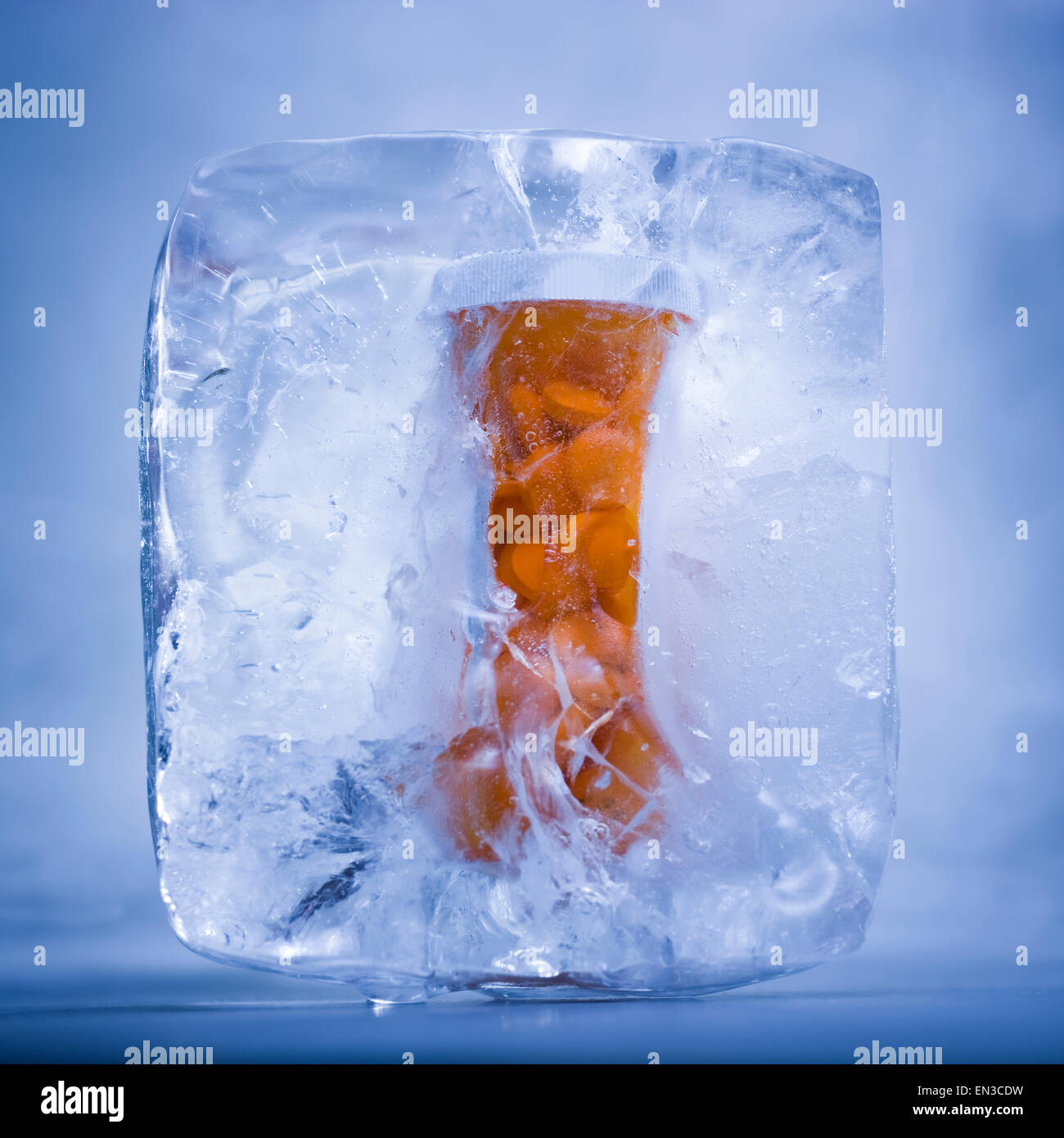 bottle of prescription drug pills frozen in ice Stock Photo