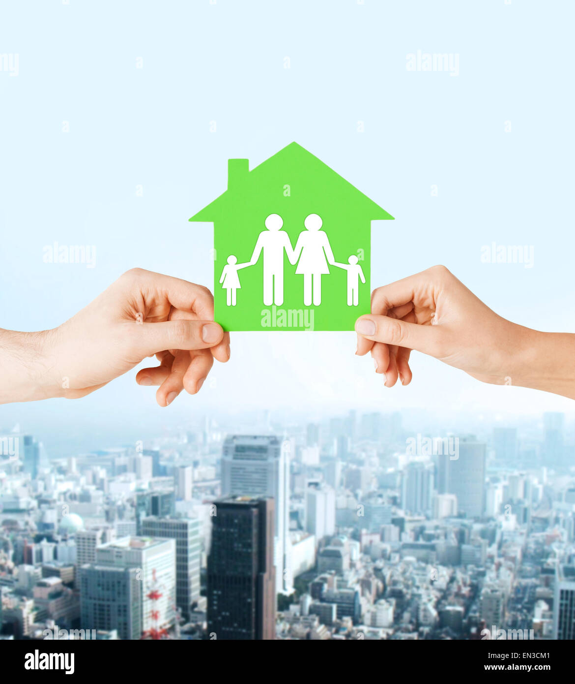 hands holding green house with family Stock Photo - Alamy