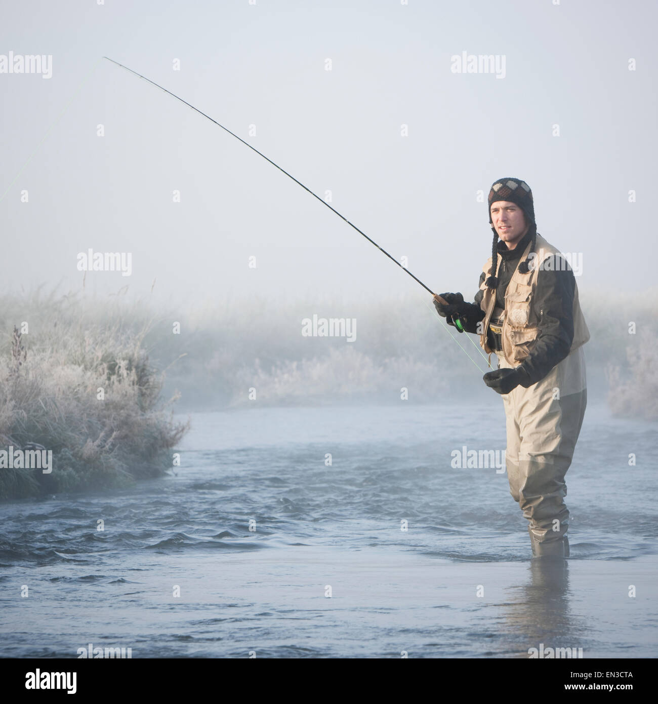 fly fisherman fishing in a mountain river Stock Photo