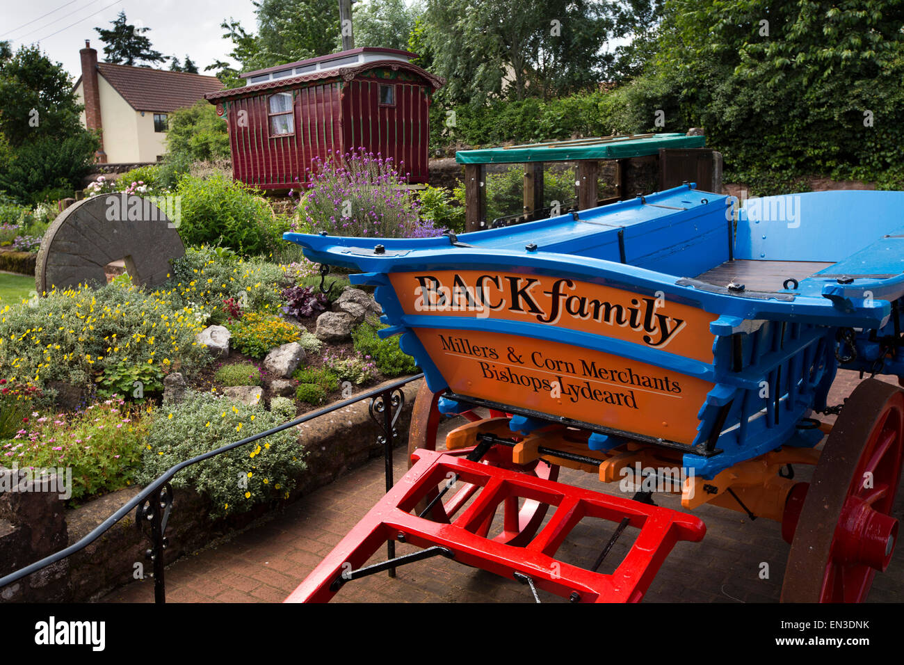 UK, England, Somerset, Taunton, Bishops Lydeard Mill, millstone and traditional gypsy caravan in garden Stock Photo