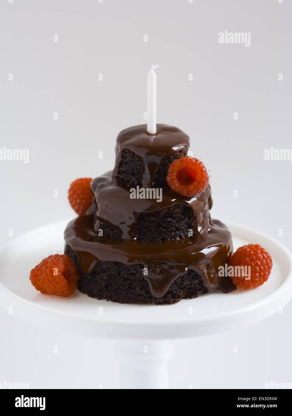 Chocolate birthday cake with raspberries and candle Stock Photo