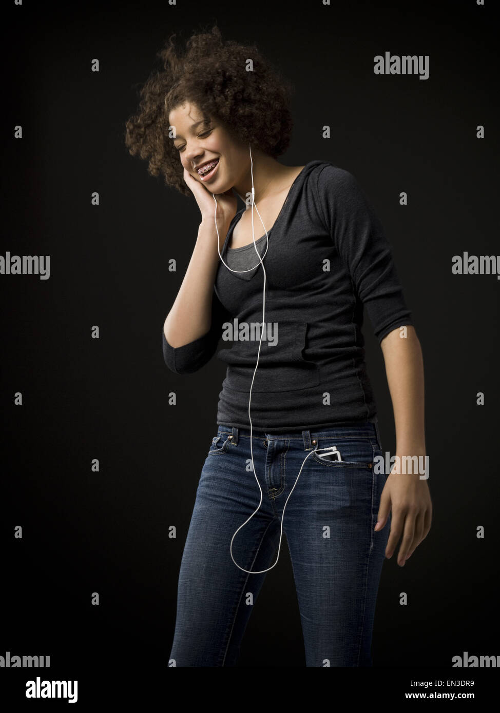Girl with braces and MP3 player dancing and smiling Stock Photo Alamy