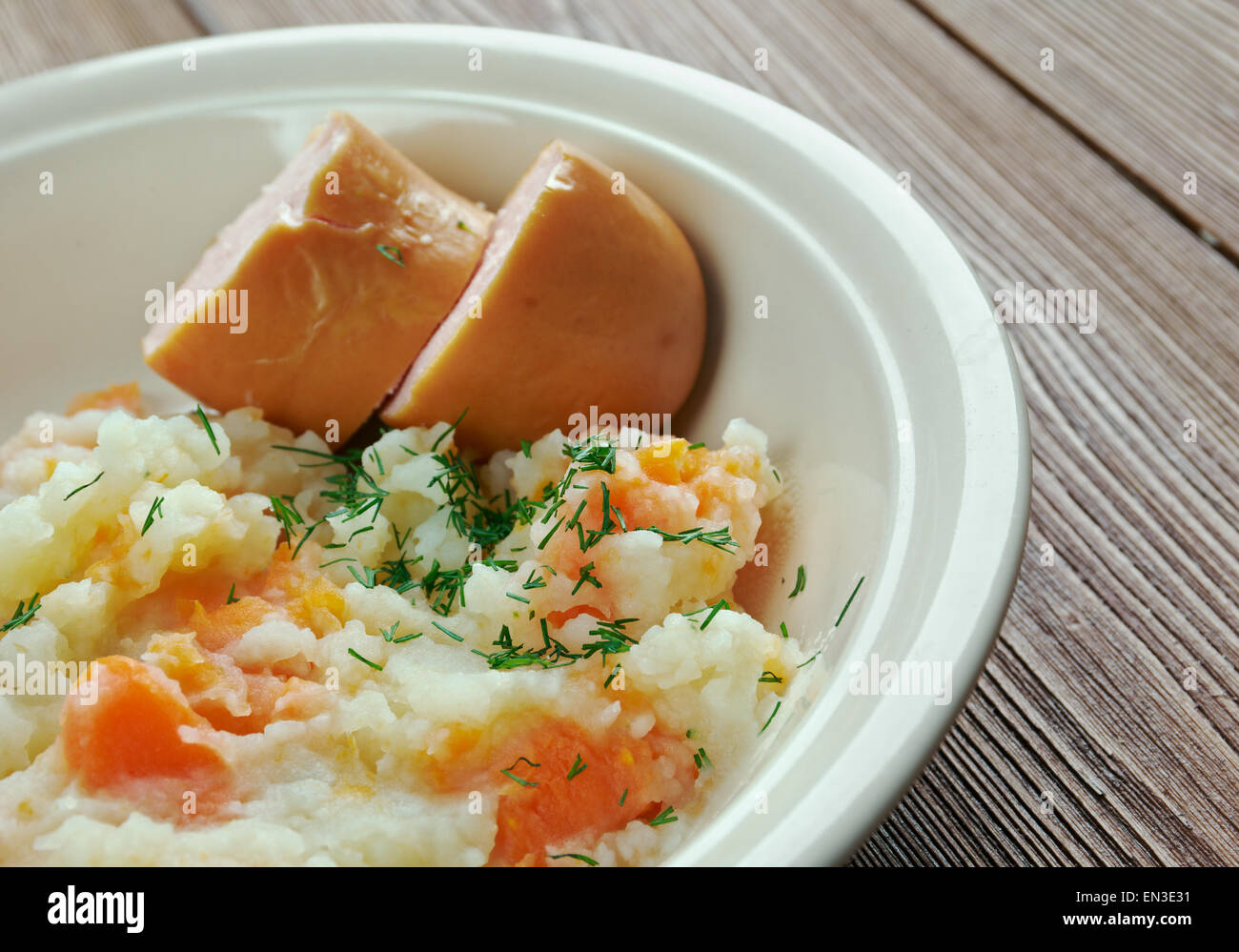 Hutspot Dutch, hochepot French or hotchpotch English, is a dish of boiled  and mashed potatoes, carrots and onions close up in the bowl on the table.  V Stock Photo - Alamy