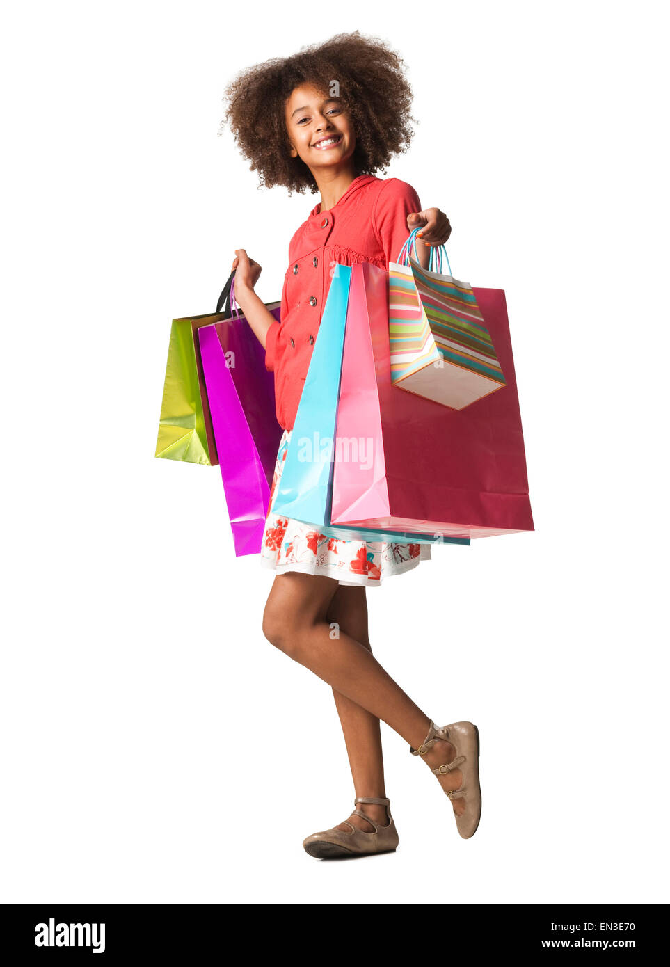 Studio shot of girl (12-13) holding shopping bags Stock Photo