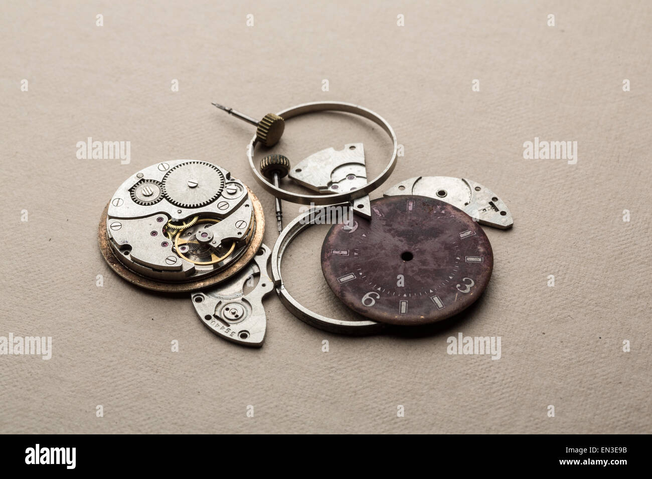 Clockwork spare parts. Metal gear, cogwheels, dial. Stock Photo