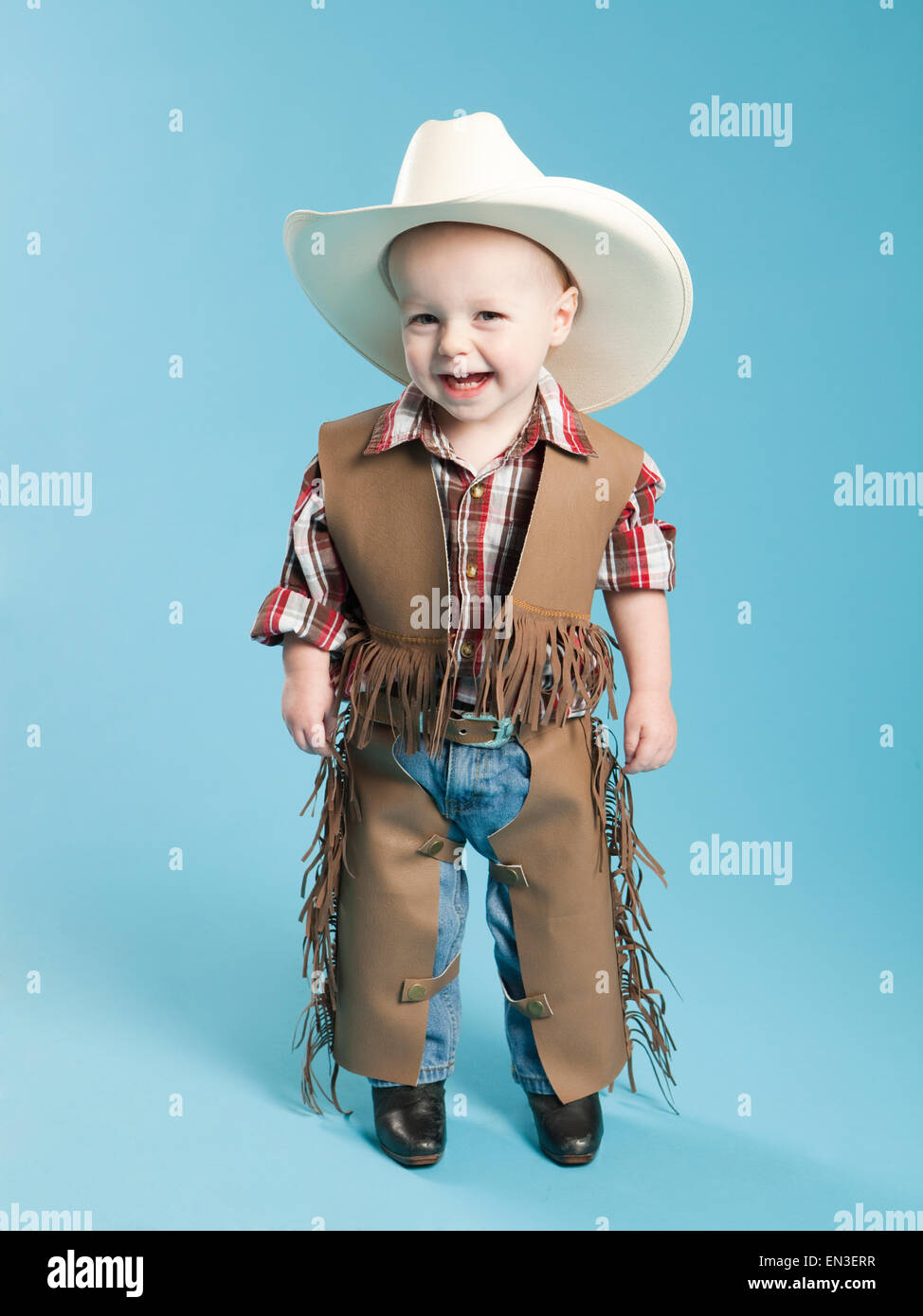 Portrait of boy (12-17 months) in cowboy costume for Halloween Stock Photo