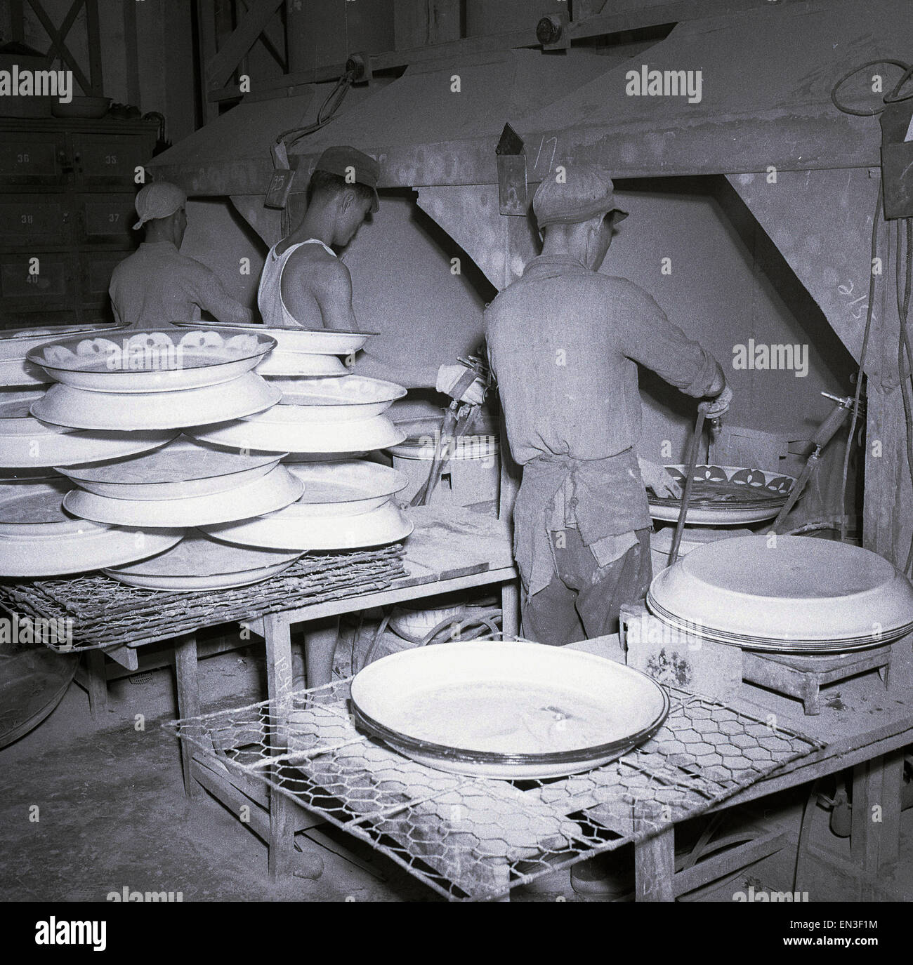1950s historical, Hong Kong, large circular ceramic plates being produced or fired from an large