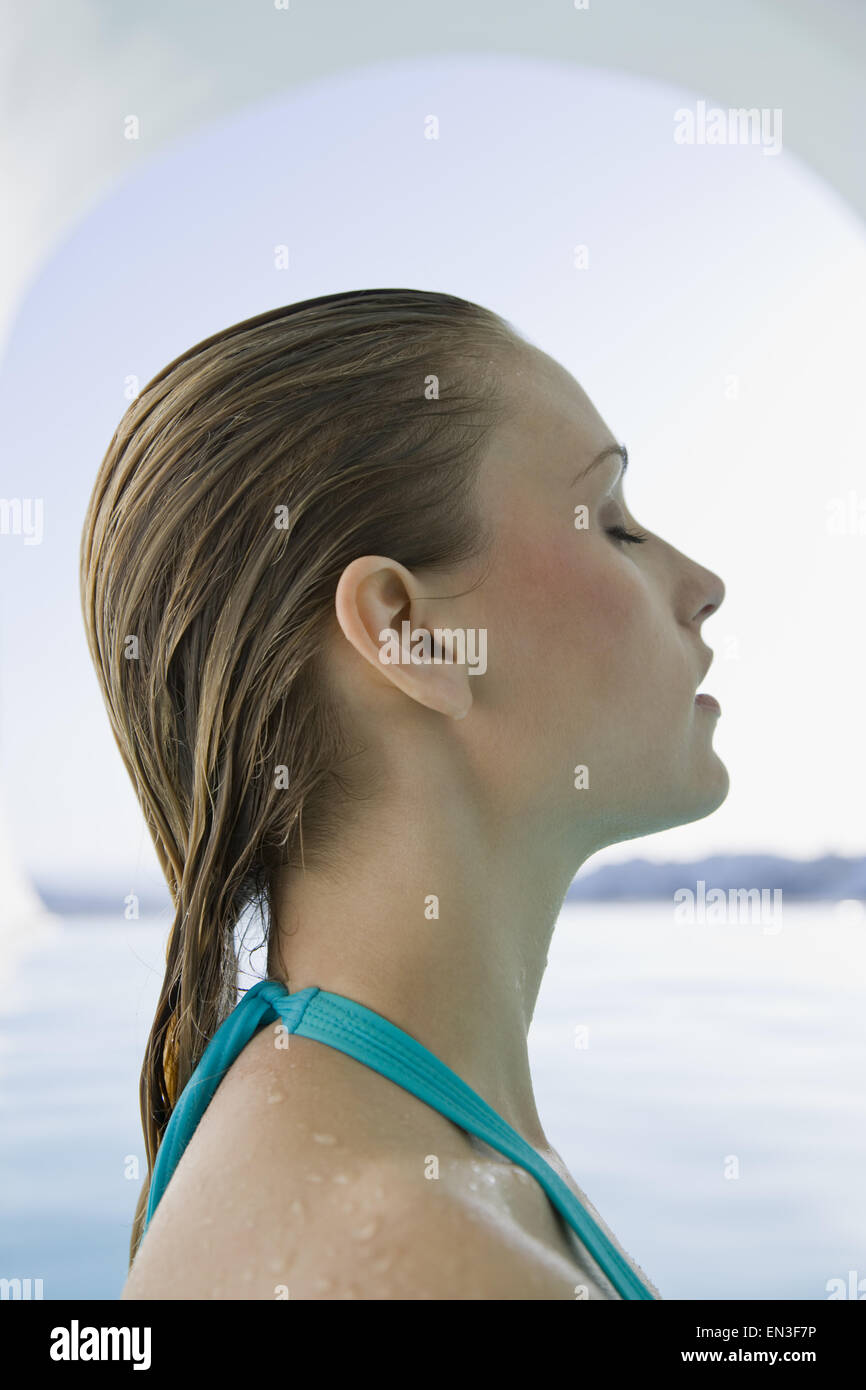 Profile of woman in bathing suit with wet hair Stock Photo