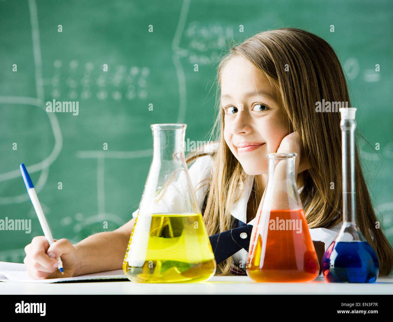 girl in a classroom with an erlenmeyer flask Stock Photo