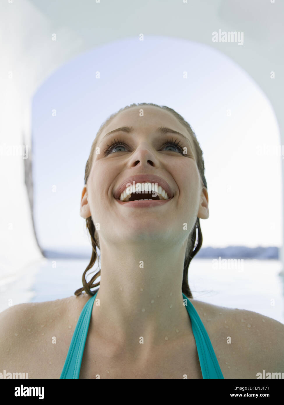 Woman in bathing suit with wet hair smiling Stock Photo