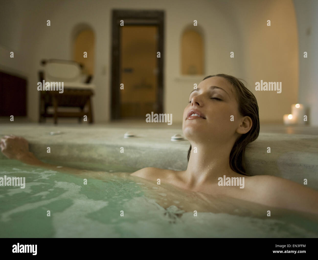 Woman in hot tub indoors Stock Photo