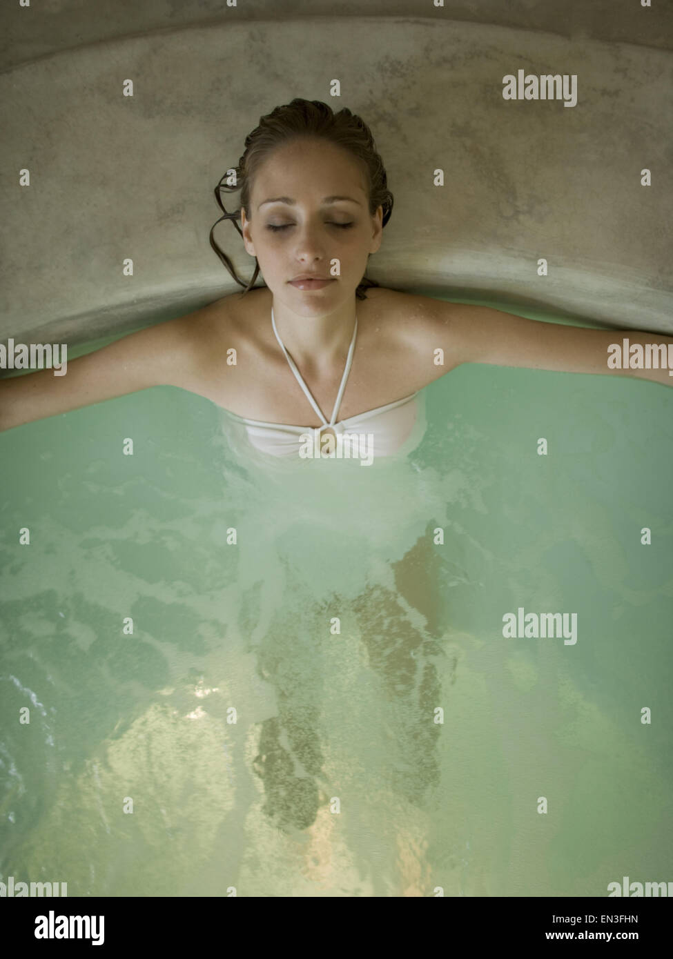 Woman in hot tub indoors Stock Photo