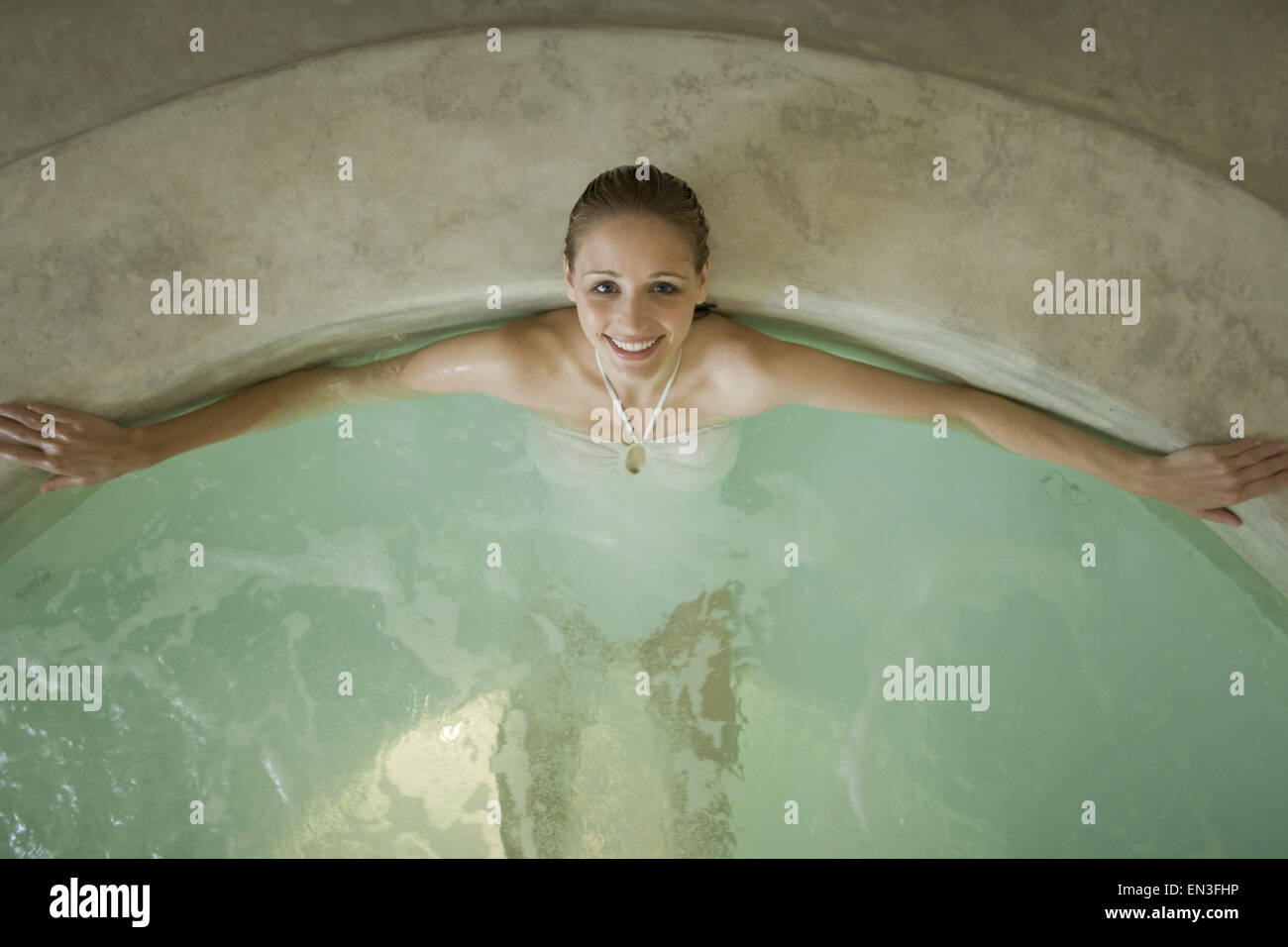 Woman in hot tub indoors Stock Photo