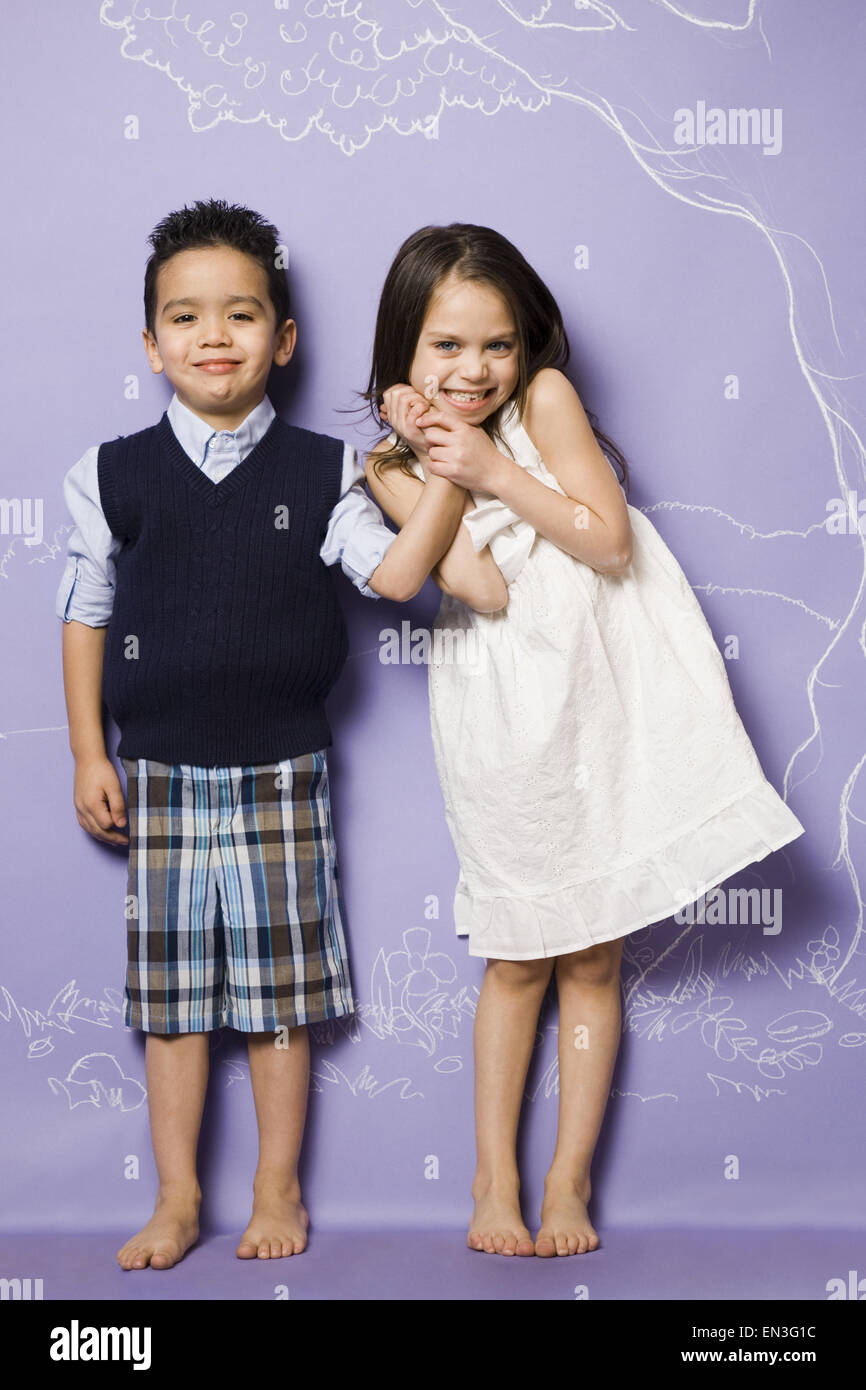 Young girl and boy holding hands smiling Stock Photo - Alamy