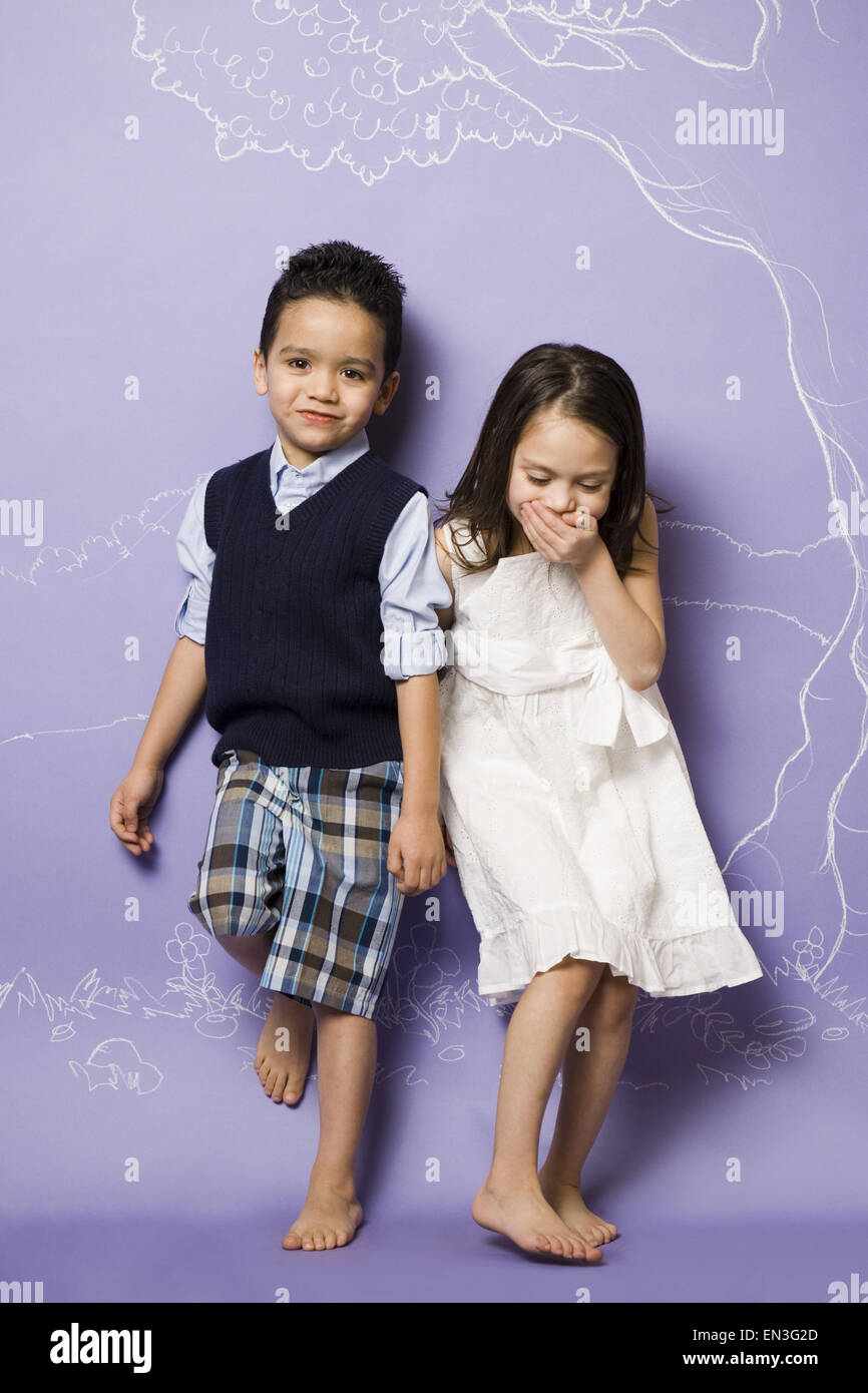 Young girl and boy holding hands smiling Stock Photo - Alamy