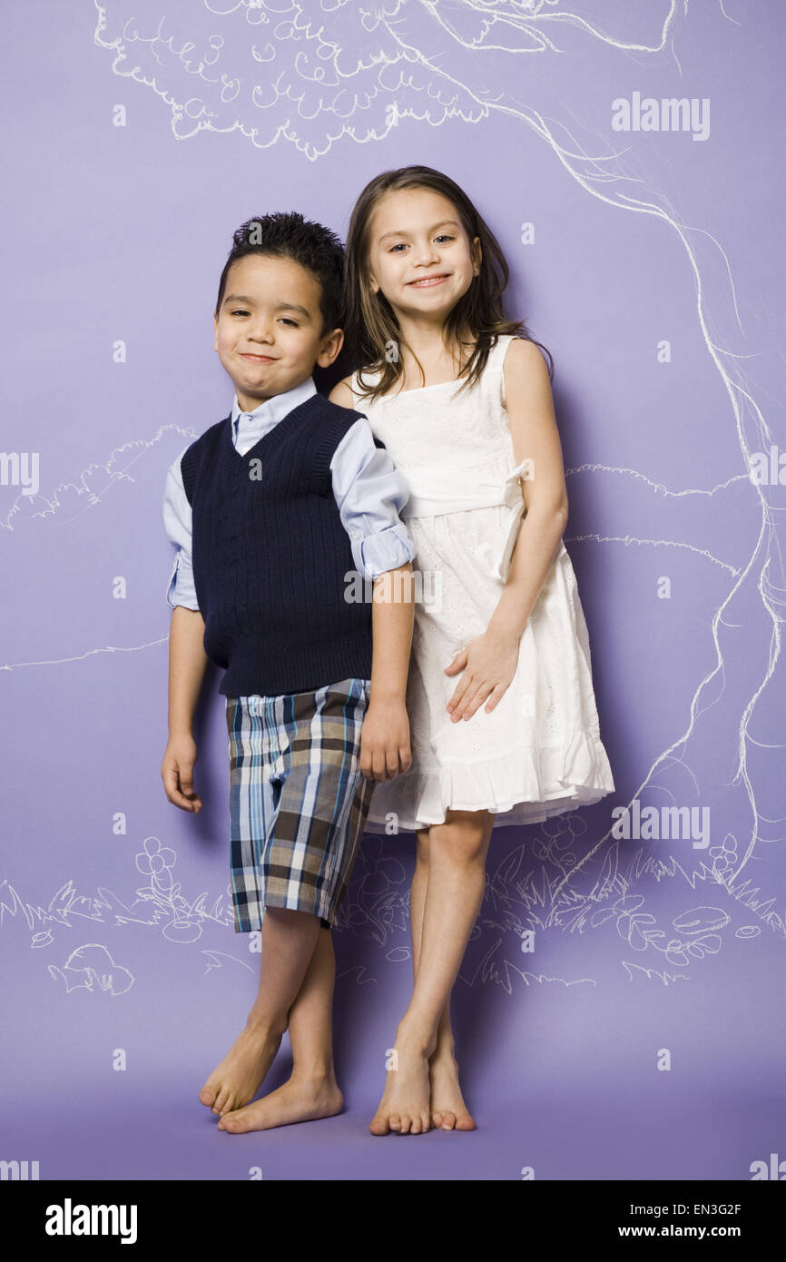 Young girl and boy holding hands smiling Stock Photo - Alamy