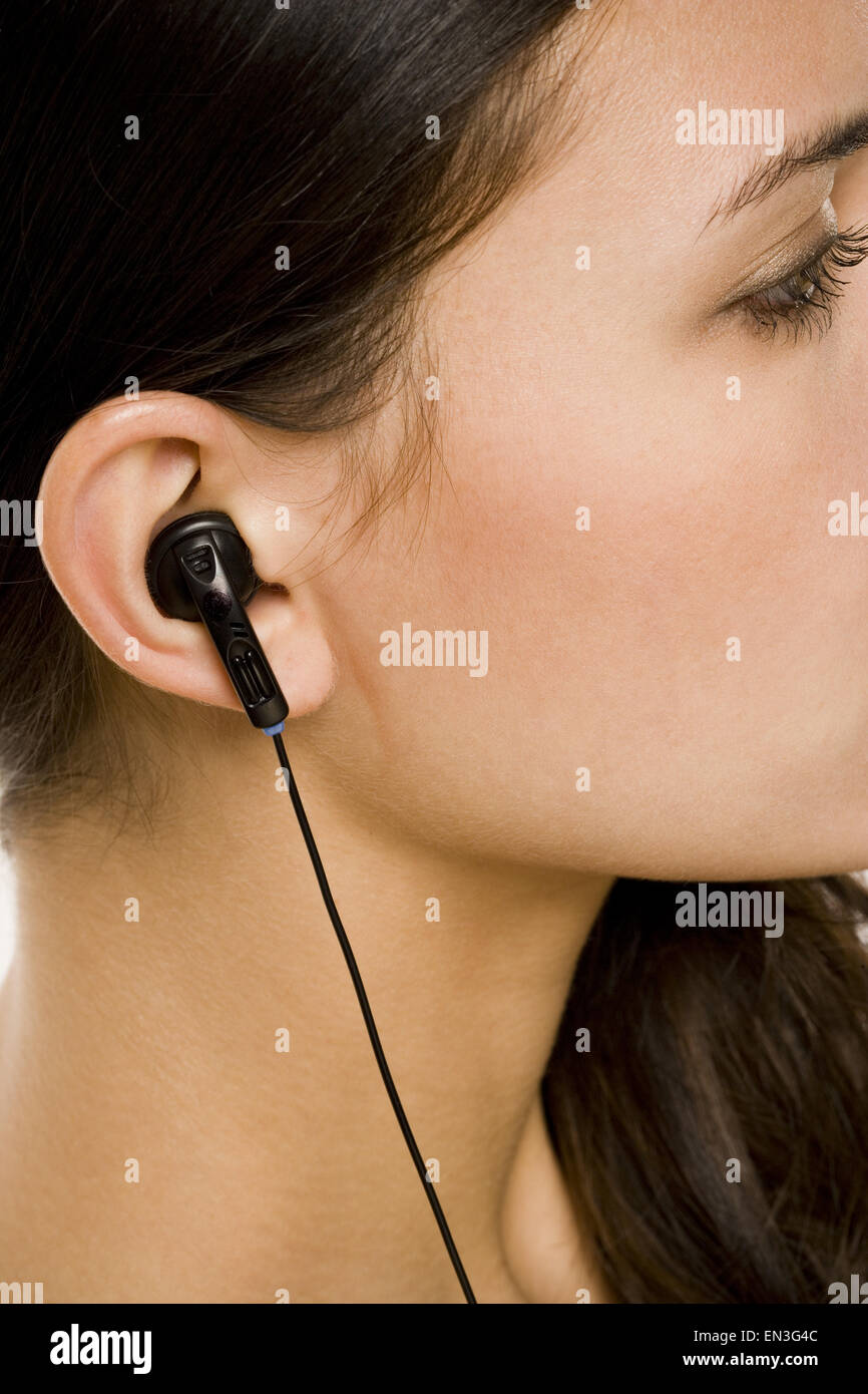 Closeup of female ear with earbud Stock Photo