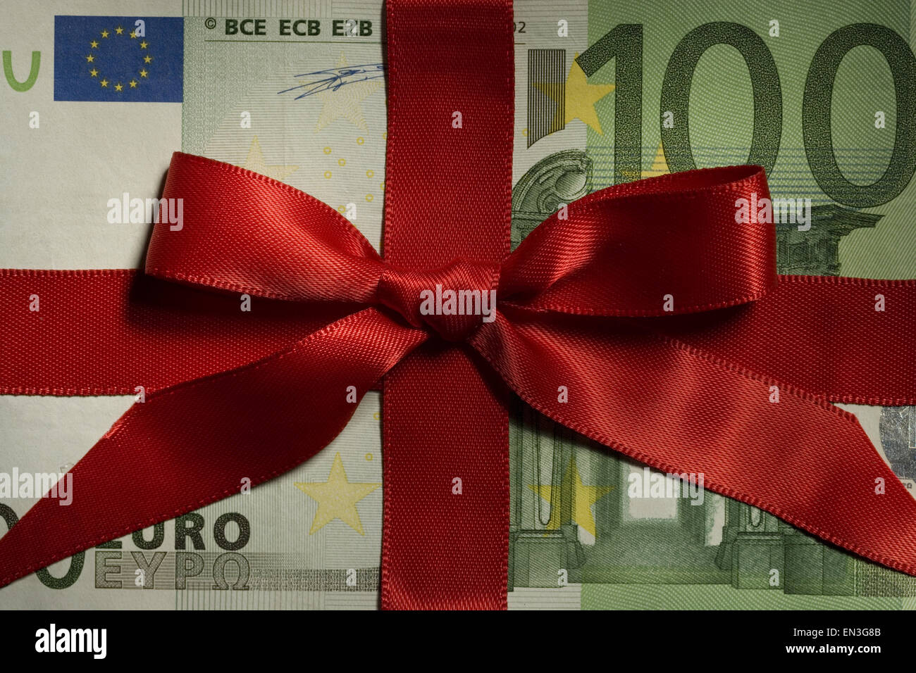 One hundred Euro banknote with red ribbon closeup Stock Photo - Alamy